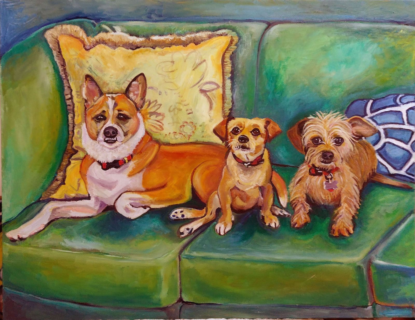 Three dogs of different breeds on a green couch, with pillows. Two are brown, one is reddish-tan.