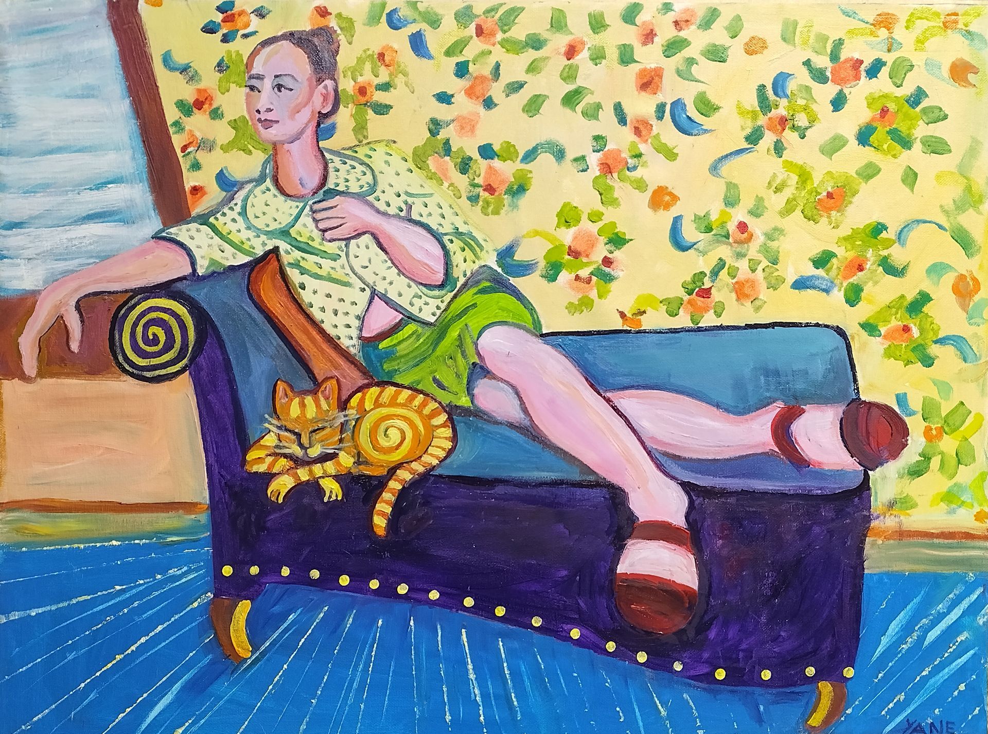 Woman in green clothing reclines on a blue couch with a cat. Floral wallpaper, blue floor.