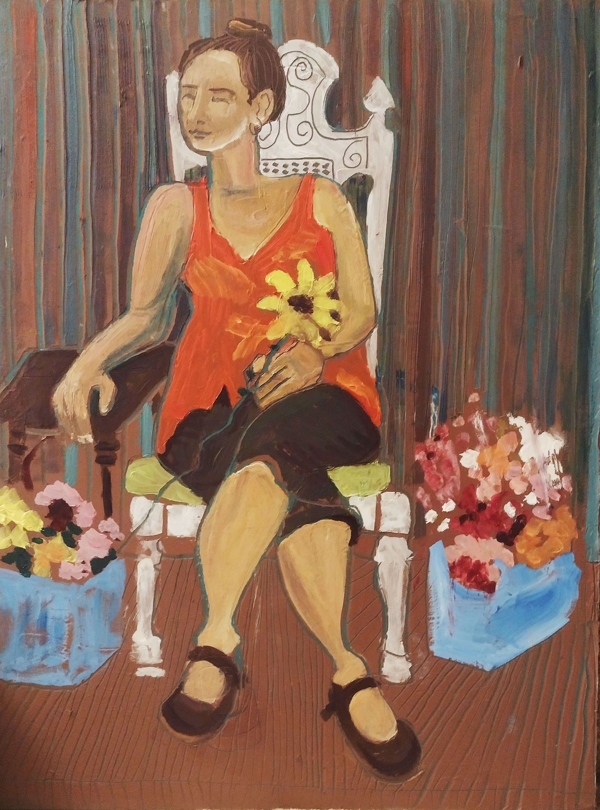 Woman seated, holding flowers, flanked by floral arrangements, orange top, white chair.