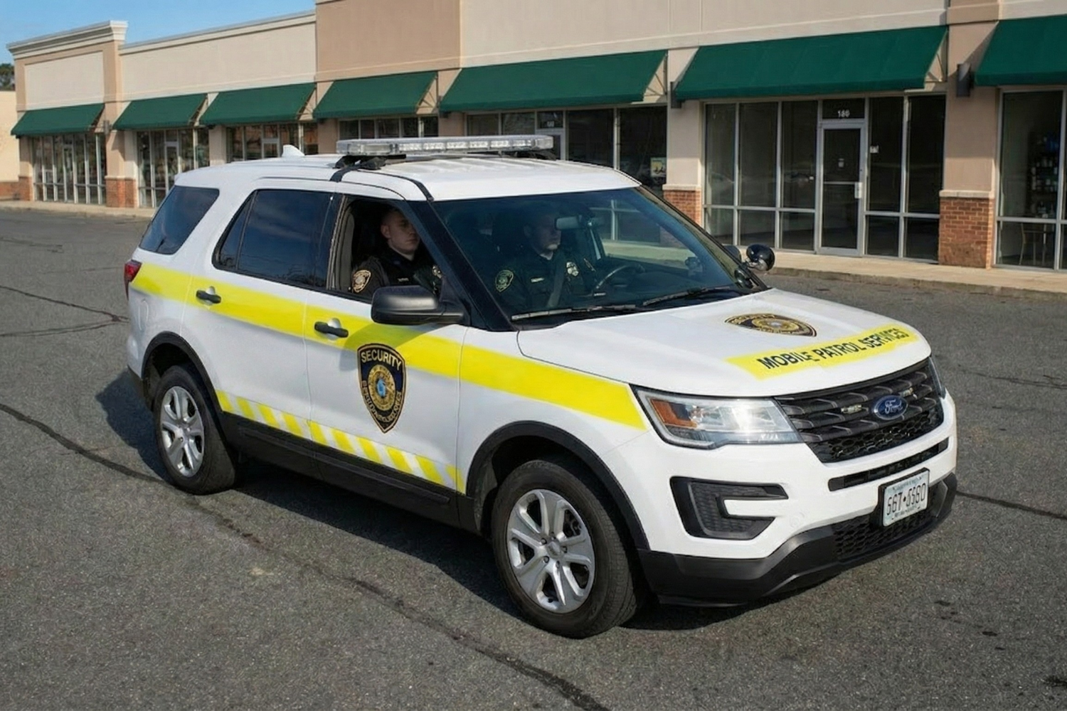 Japanese police car with flashing lights on a city street.