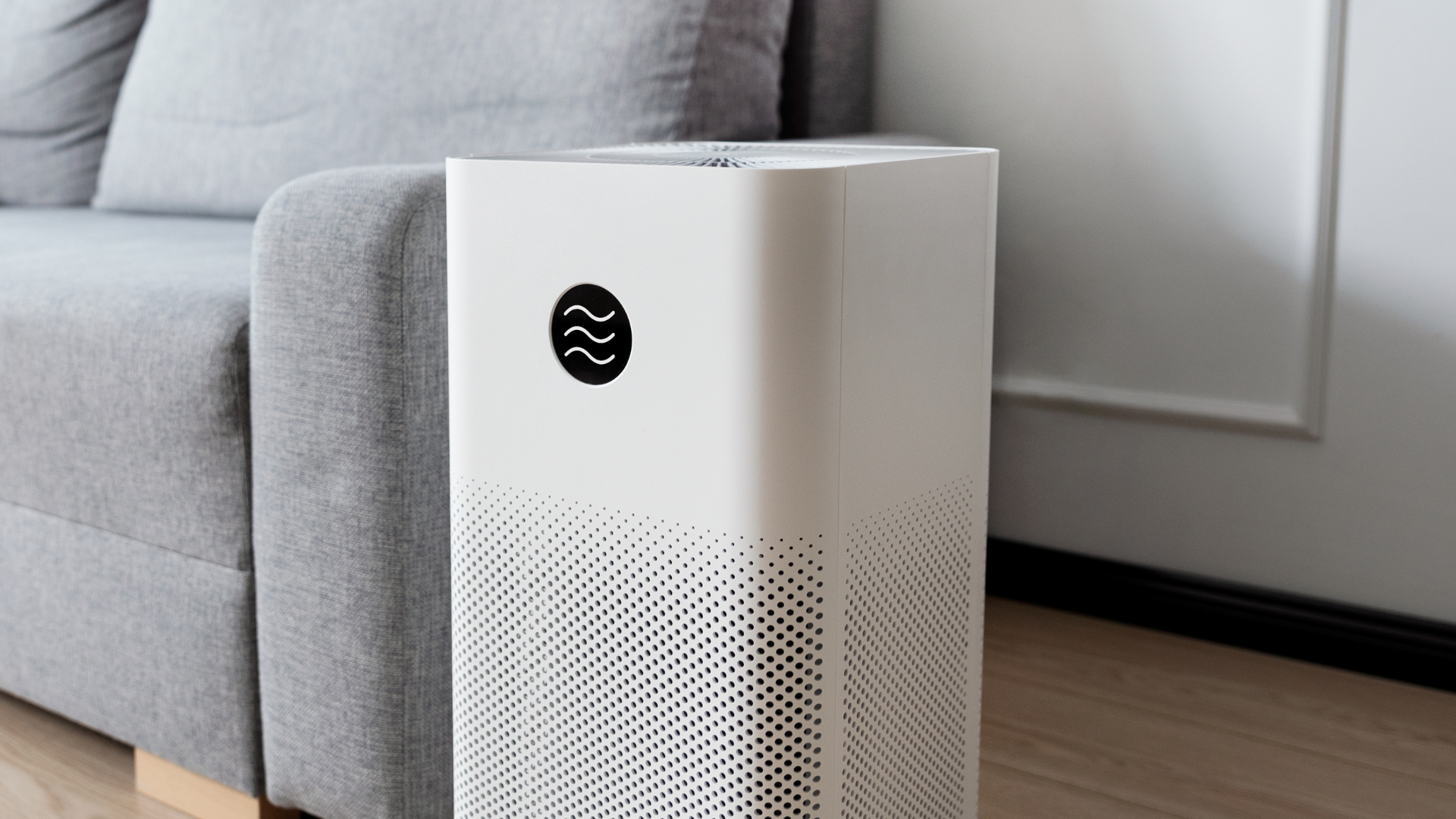 Three wall-mounted dispensers: liquid soap (orange), hand sanitizer (white), and paper towels (white).