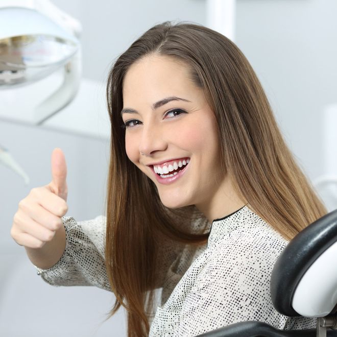 Teeth Cleaning — Smiling Woman With Thumbs Up in Akron, Oh