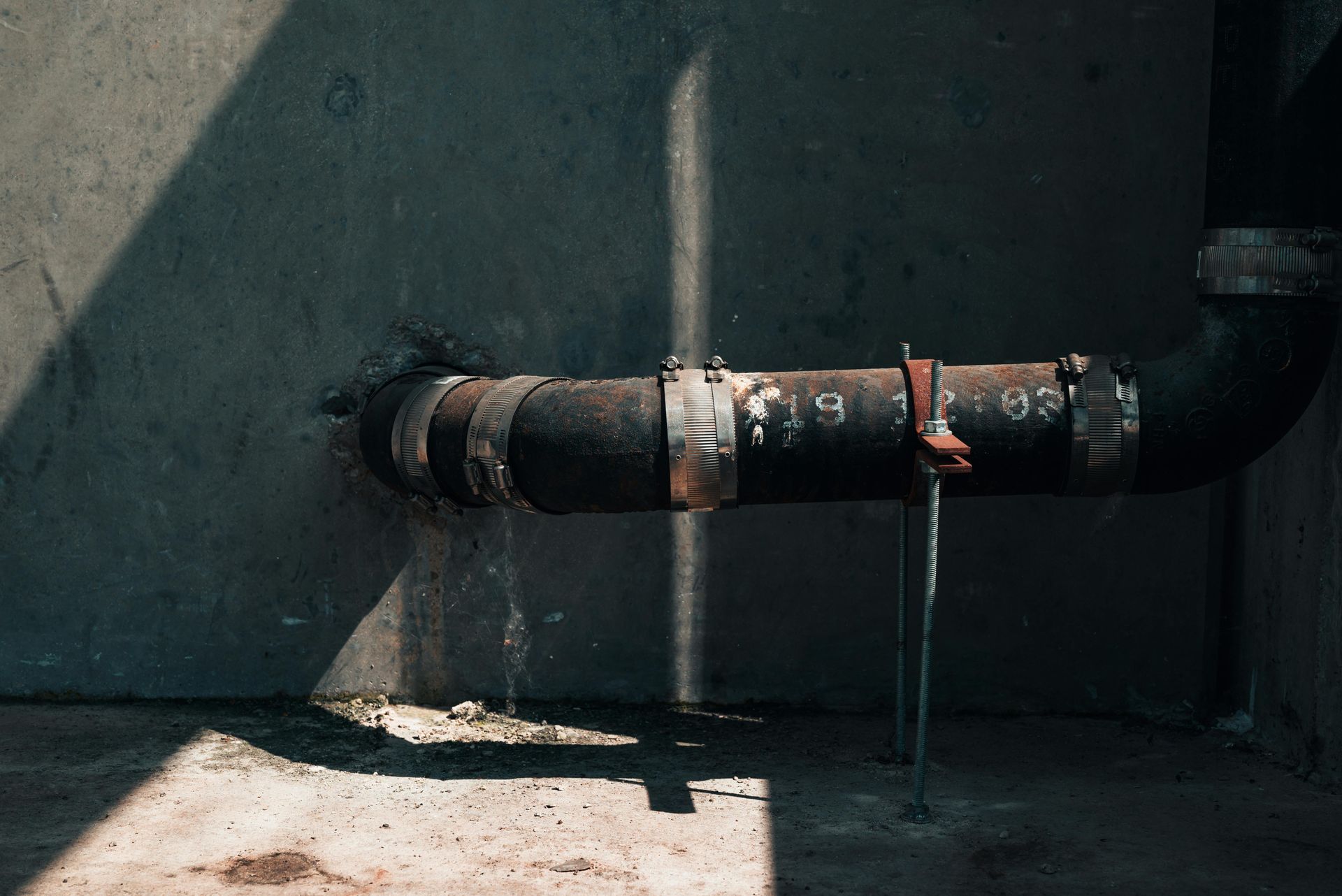 A close up of a rusty pipe in a room.