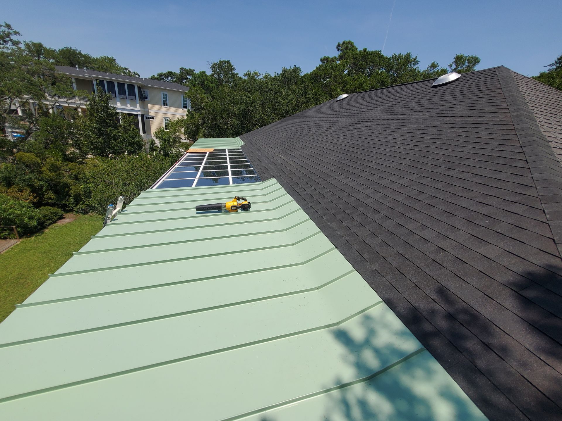 A roof with a green roof and a black roof.
