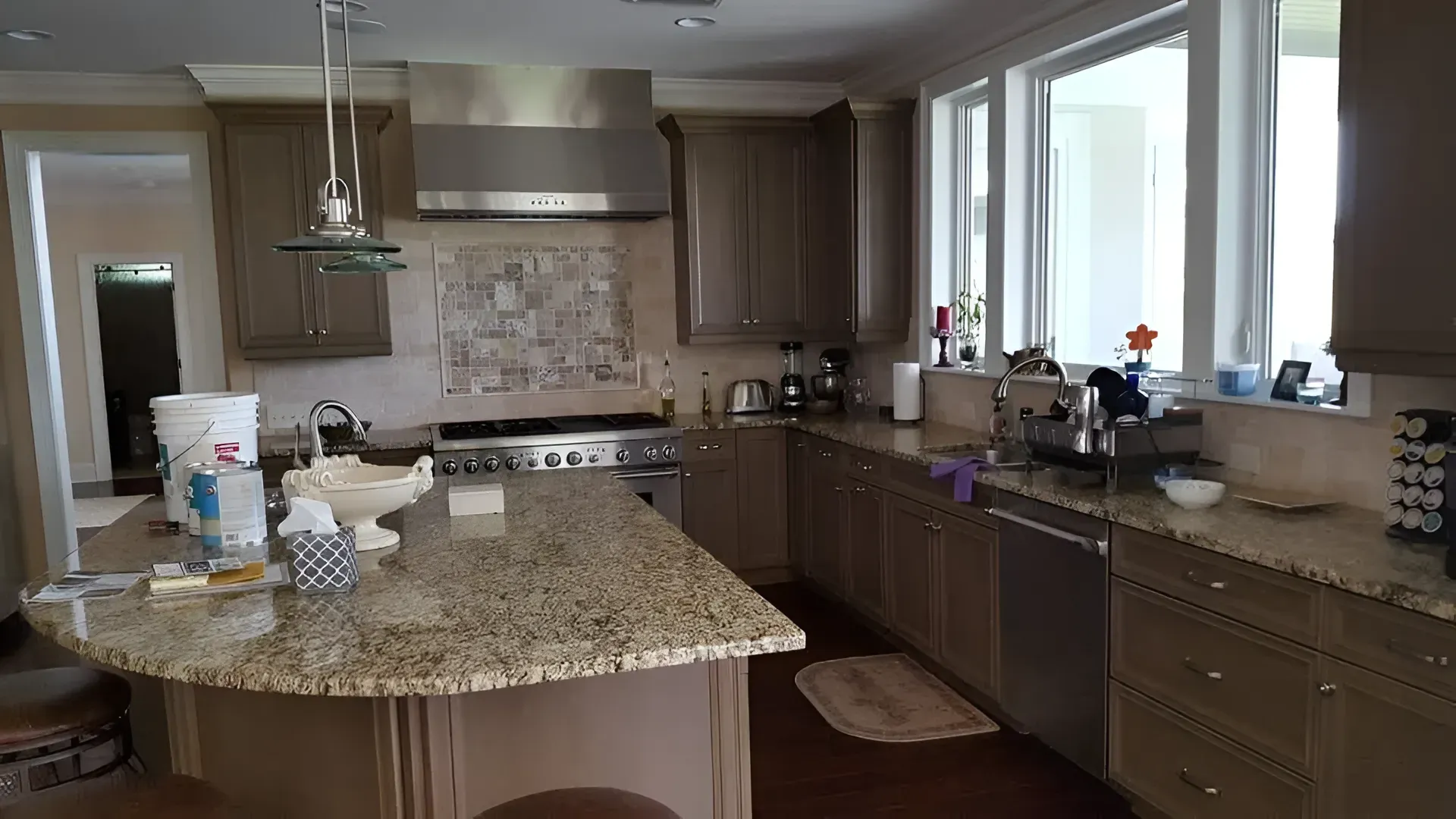 darker grey cabinets, granite counter tops in an l shaped kitchen with an island. 