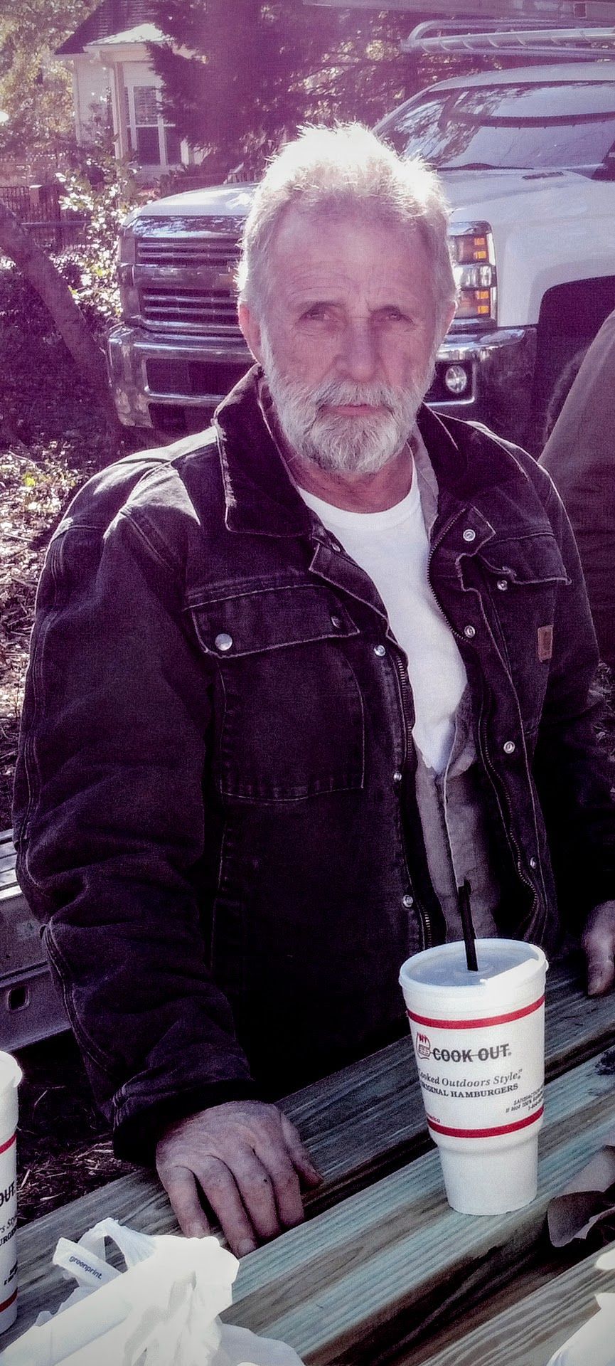 A wooden deck with stairs leading up to a swimming pool.