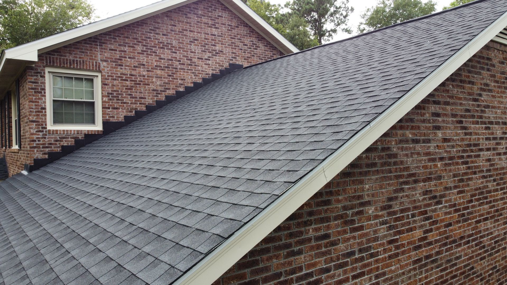 An aerial view of a house with a brown roof.