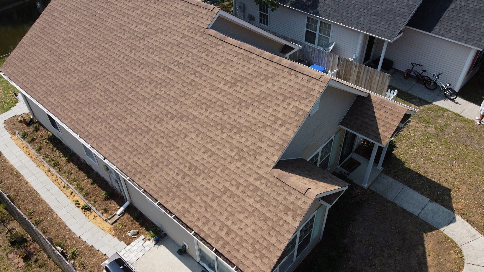 An aerial view of a house with a brown roof.