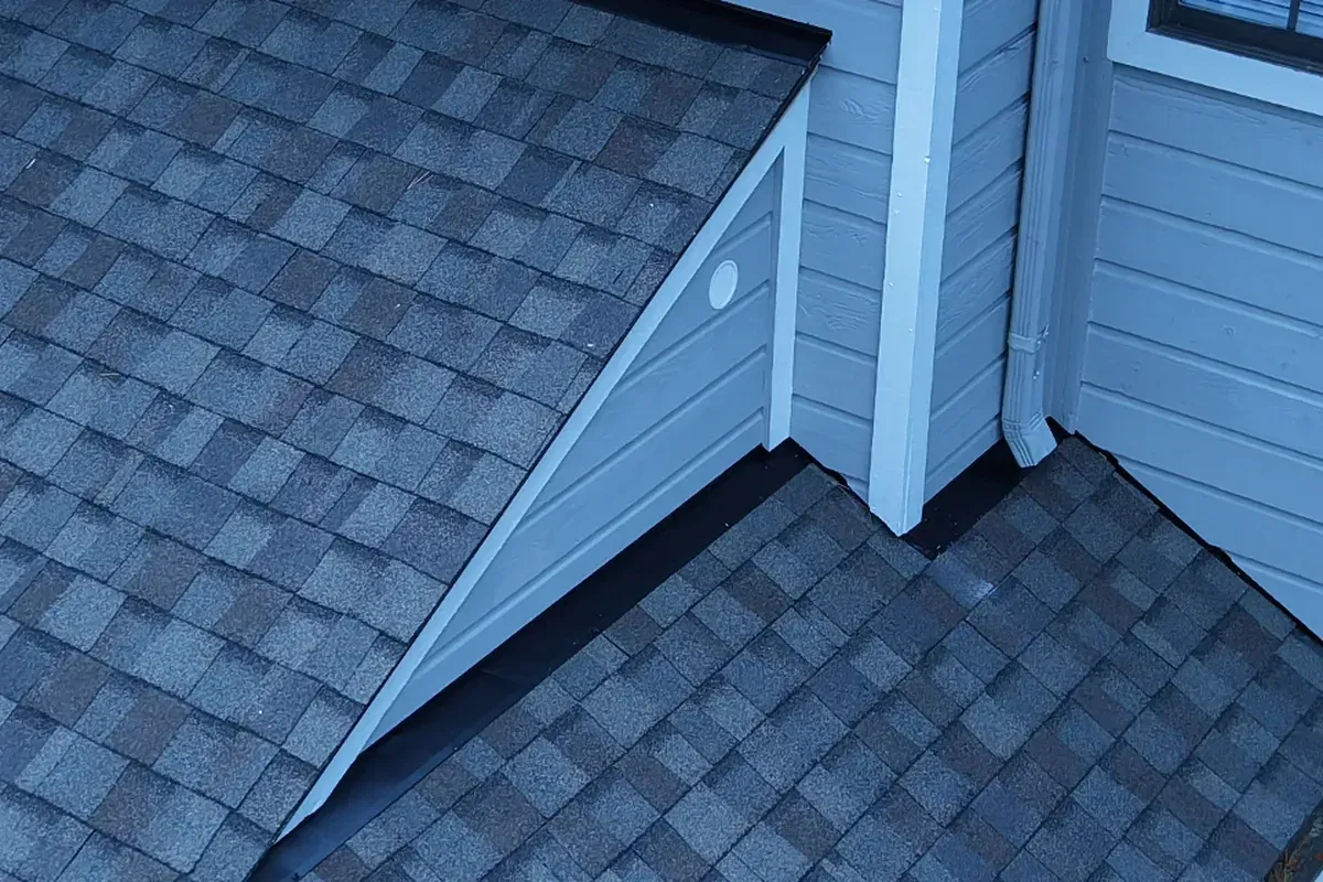 Local shingle roofing specialists in Wilmington installing new architectural shingles with upgraded sidewall flashing on a coastal Carolina home.