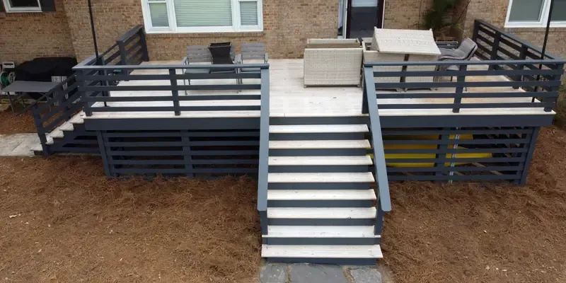 Pressure treated deck, stairs, and railing built on home exterior and painted in Wilmington NC