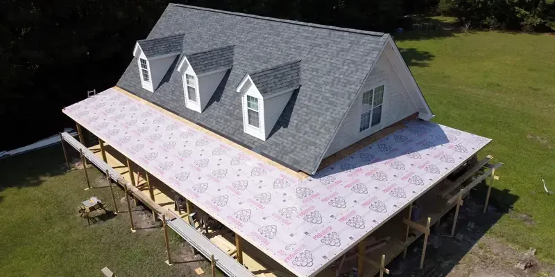Wrap  around farmers porch with roof covered with synthetic paper