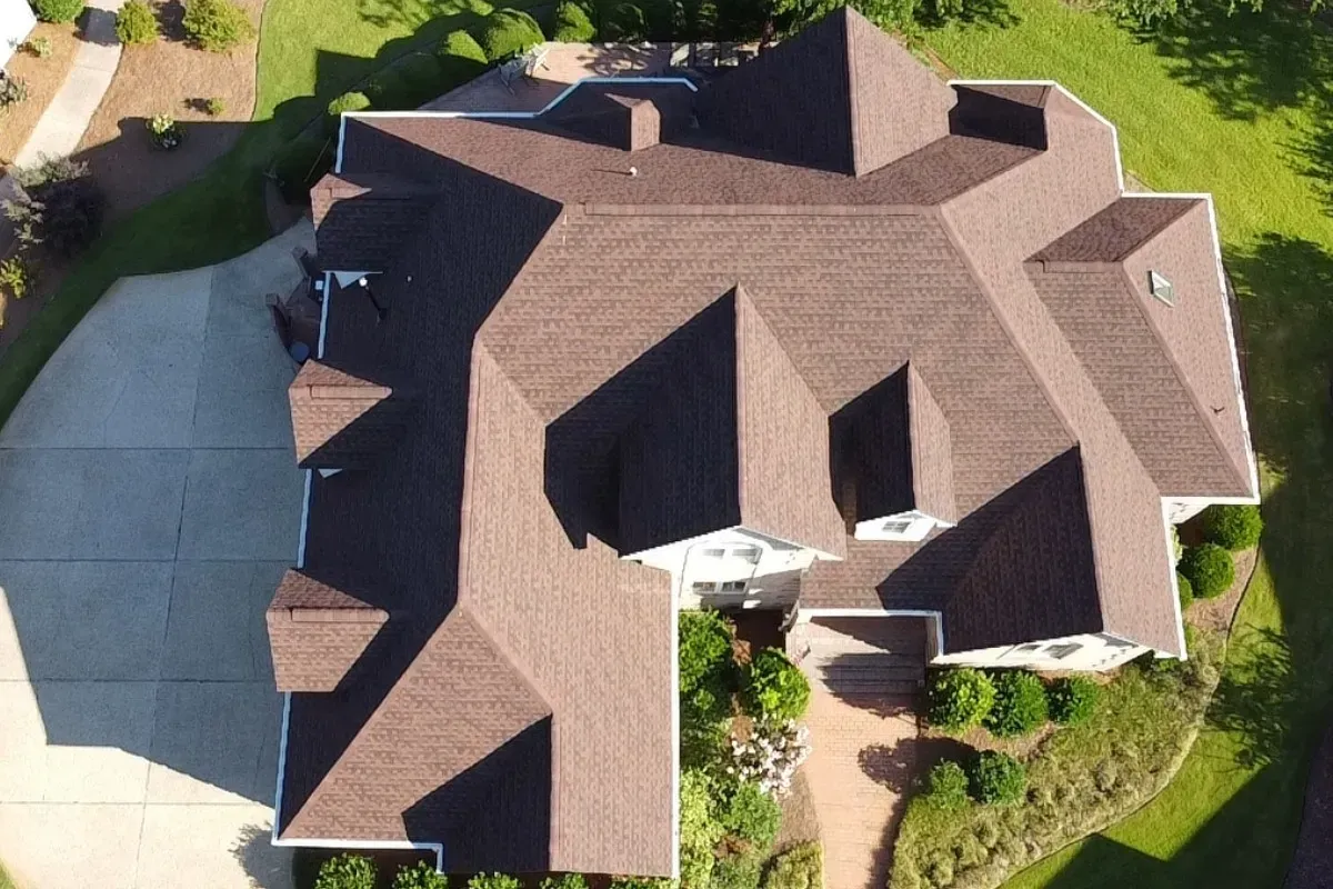 After shingle roof replacement in Porters Neck Wilmington NC featuring new GAF Timberline HDZ Hickory shingles with upgraded underlayment, ice and water shield, ridge vent, and updated flashing.