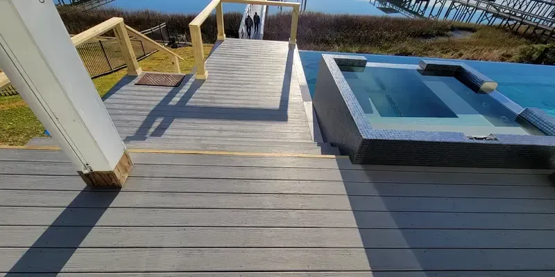 Finished composite deck surface near pool corner with clean transition and low-maintenance boards