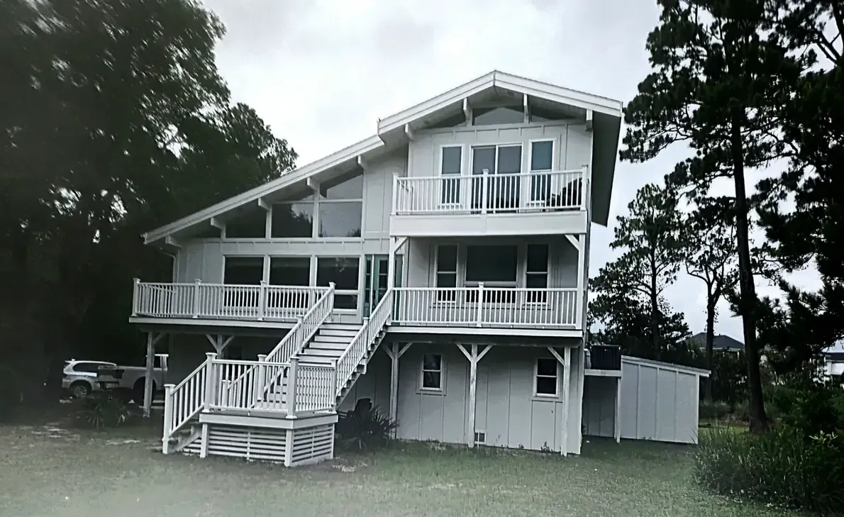 Multi level composite deck with pvc railings on coastal home