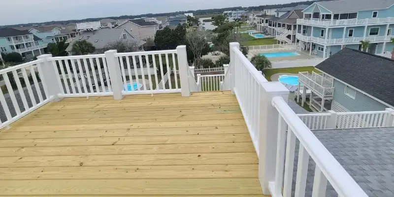New deck boards with white railing overlooking neighborhood in Holden Beach NC