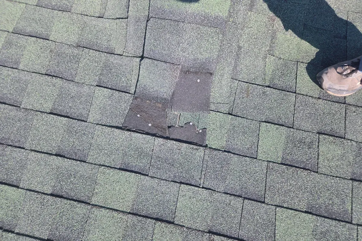 Blown-off ridge caps identified during a roof inspection on a Wilmington, NC home.