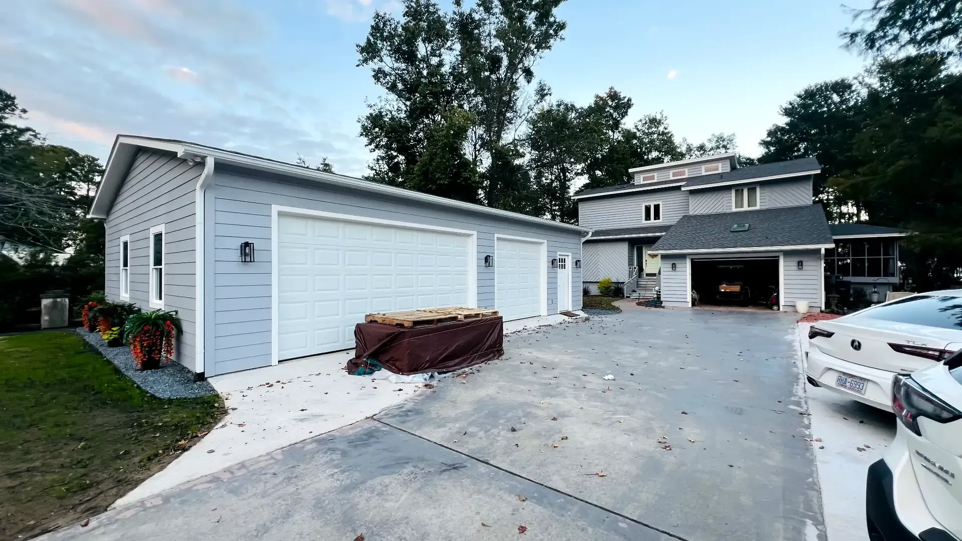 Two car garage with fiber cement siding and architectural roof.