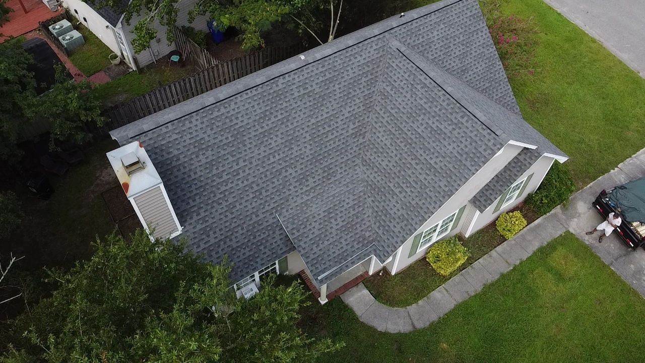An aerial view of a house with a new roof.