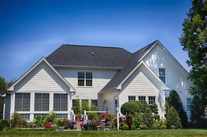 A large white house with a black roof.