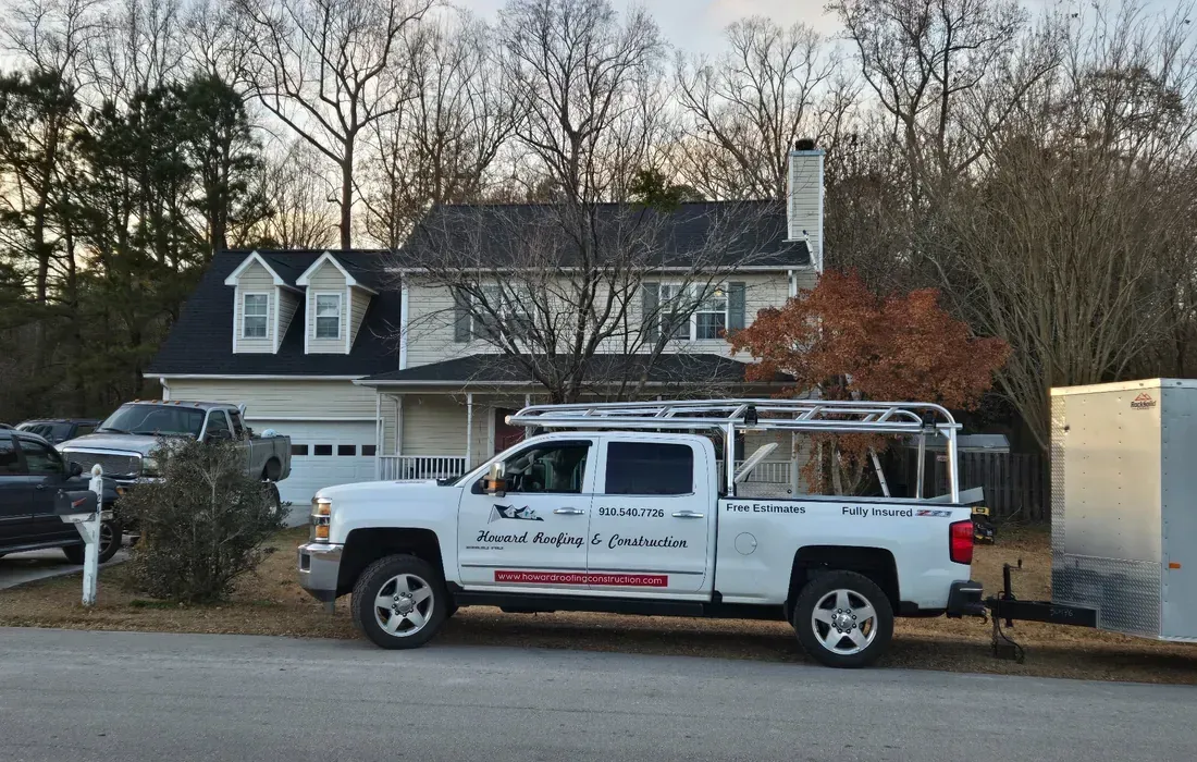 Company truck sitting in front of a Jacksonville, NC full roof replacement job.