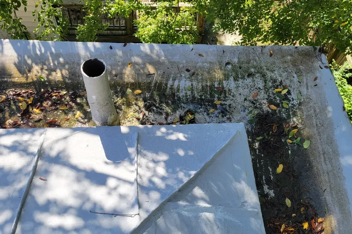 Roof leak caused by rotten built in gutter on old building in historic district in Wilmington, NC.