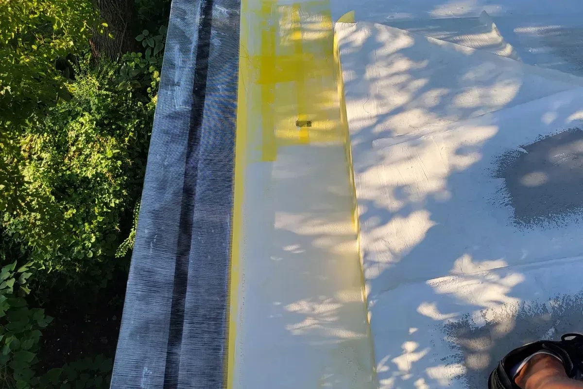 Wire mesh being added to the synthetic roof coating for added durability in Wilmington.