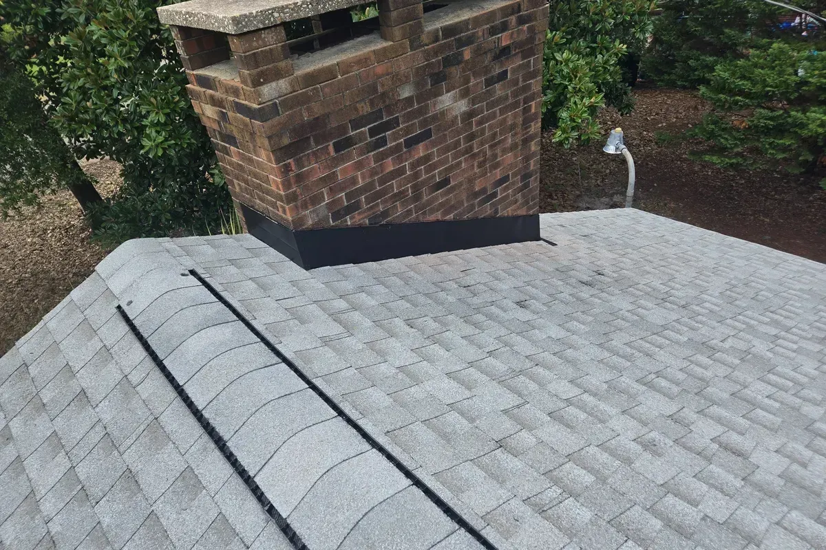 Completed roof repair in Wilmington NC with new chimney flashing installation and freshly sealed shingles.