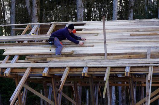 A man is working on a wooden structure.