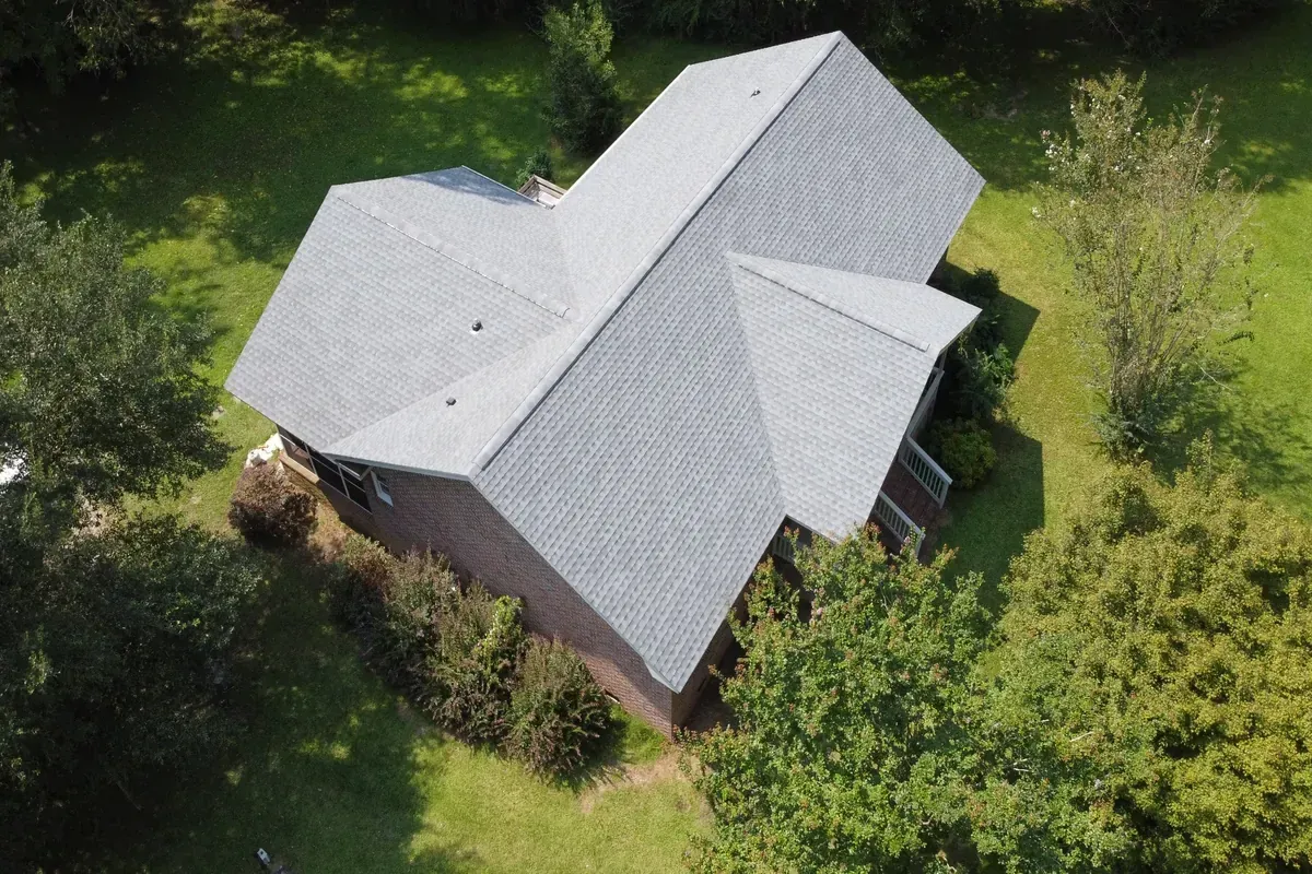 Architectural shingle roof installation on a ranch style home with two dormers. 