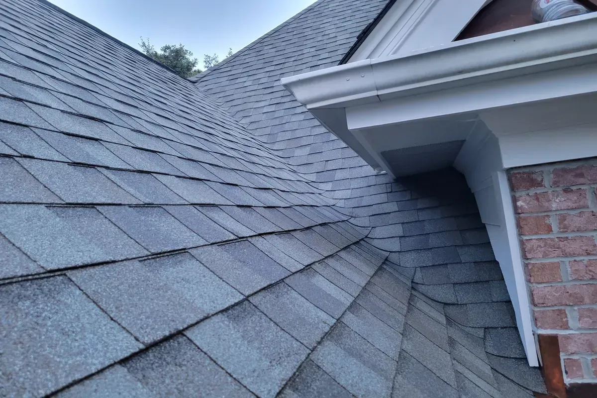 Finished roof repair seamlessly blended into the existing shingles.