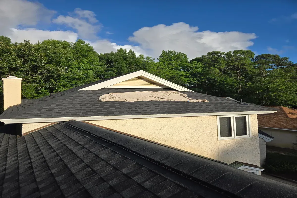 Hip roof with architectural shingles and ridge vent.