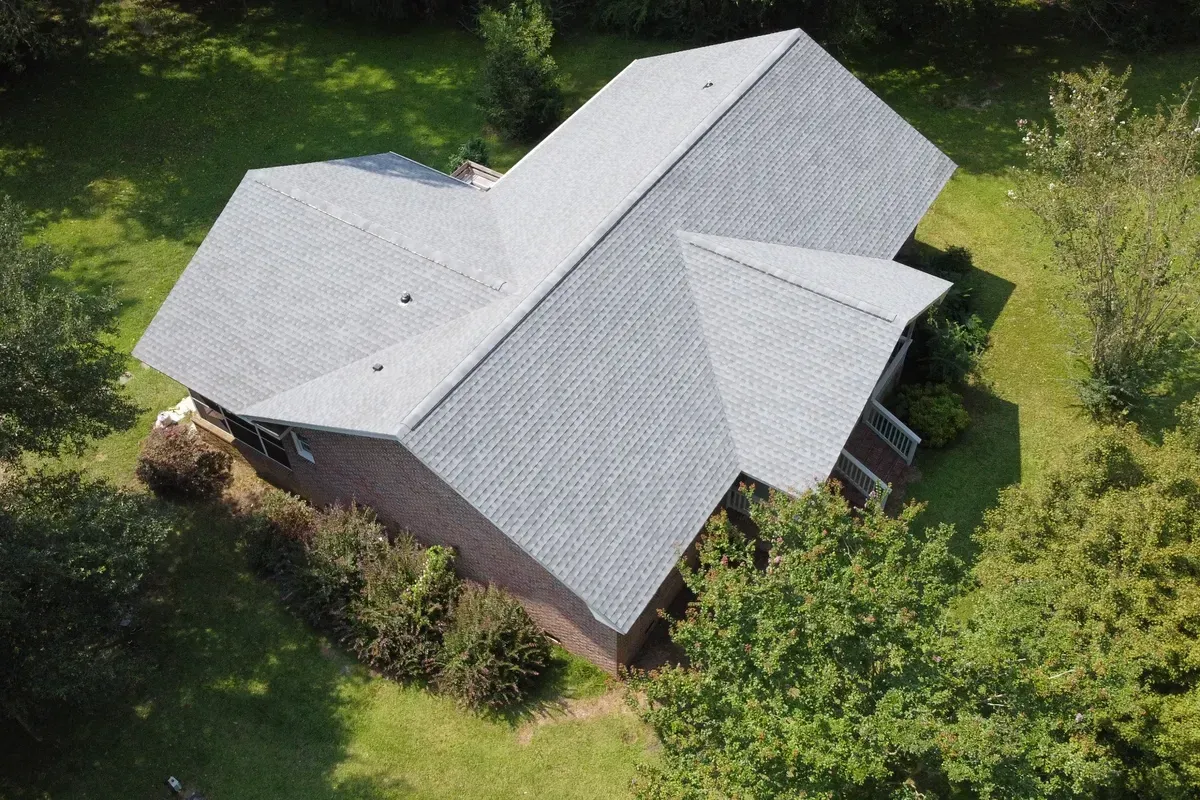 Shingle roofing company Wilmington NC installing a complete GAF Timberline HDZ roofing system on a multi-roofline brick home.