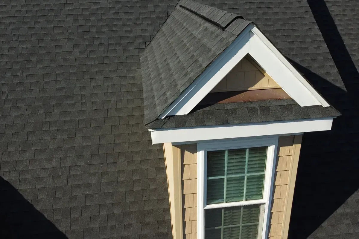 Shingle roofing specialist Wilmington installing architectural shingles with clean ridge lines and proper flashing details on a coastal North Carolina roof.