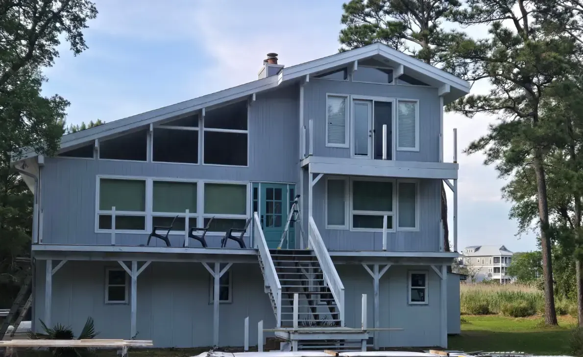 Photo showing the old wood siding and current condition of the exterior of the home before new siding installation.