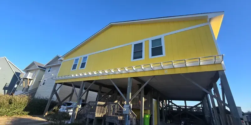 		Smart side t1-11 siding installation and exterior paint job on elevated coastal home in Topsail Beach NC with wraparound exterior protection
