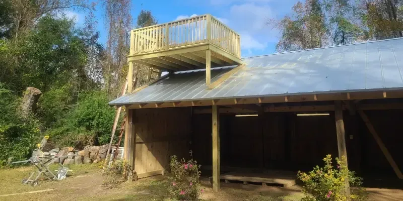 Barn with pine board and batten siding,  5v metal roof with a rooftop deck
