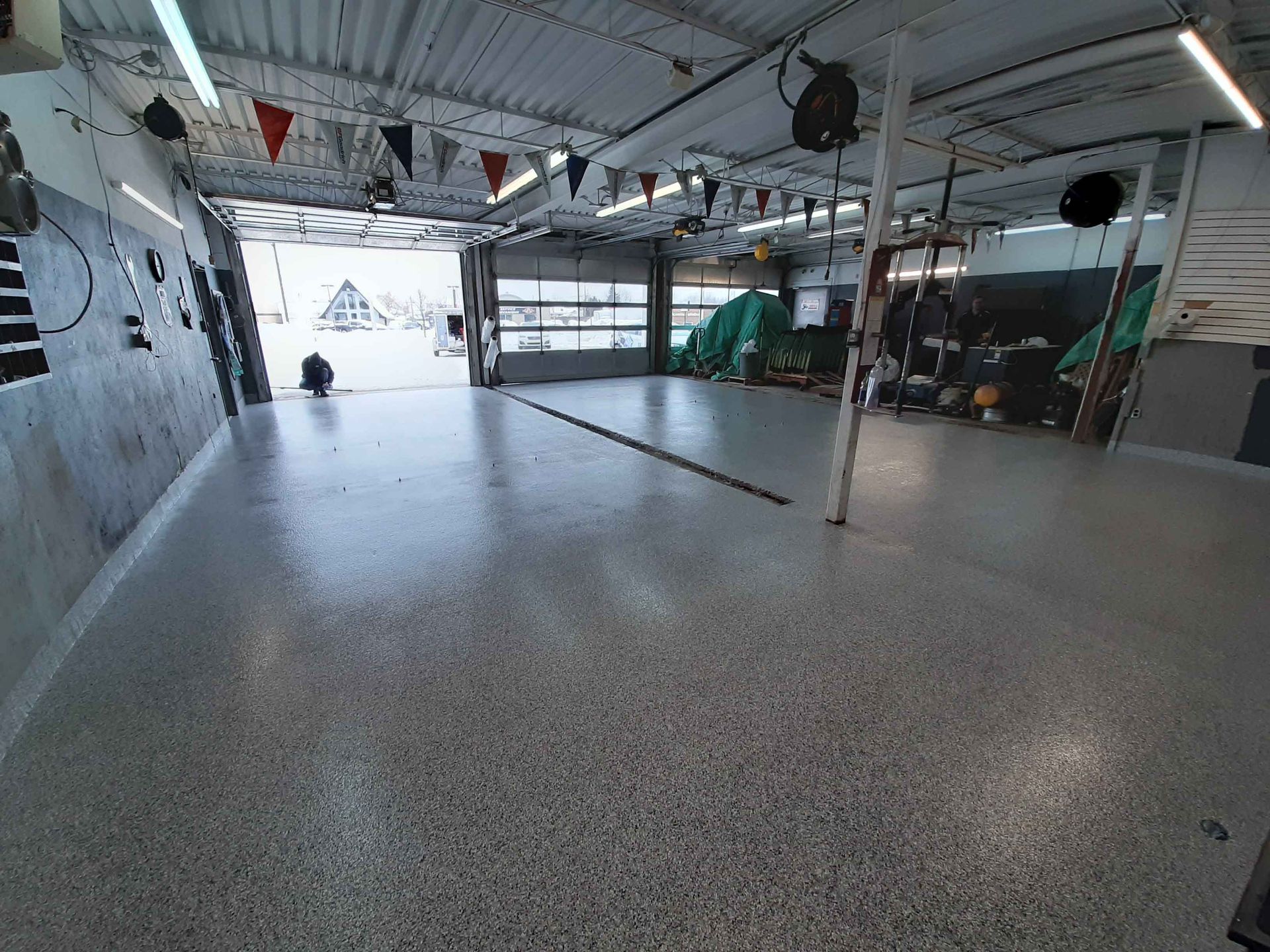 A large empty garage with a concrete floor.