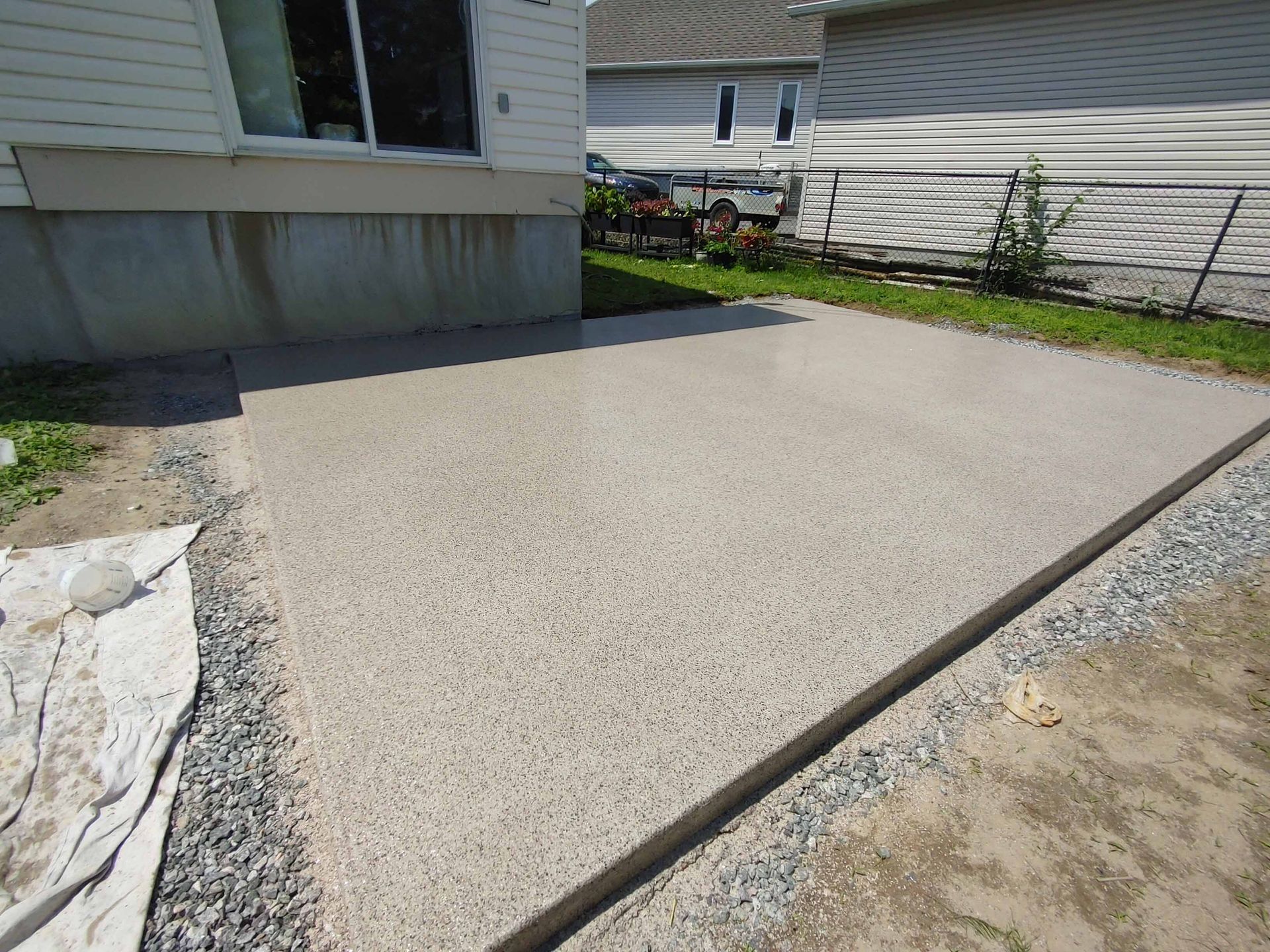 A concrete driveway is being built in front of a house.