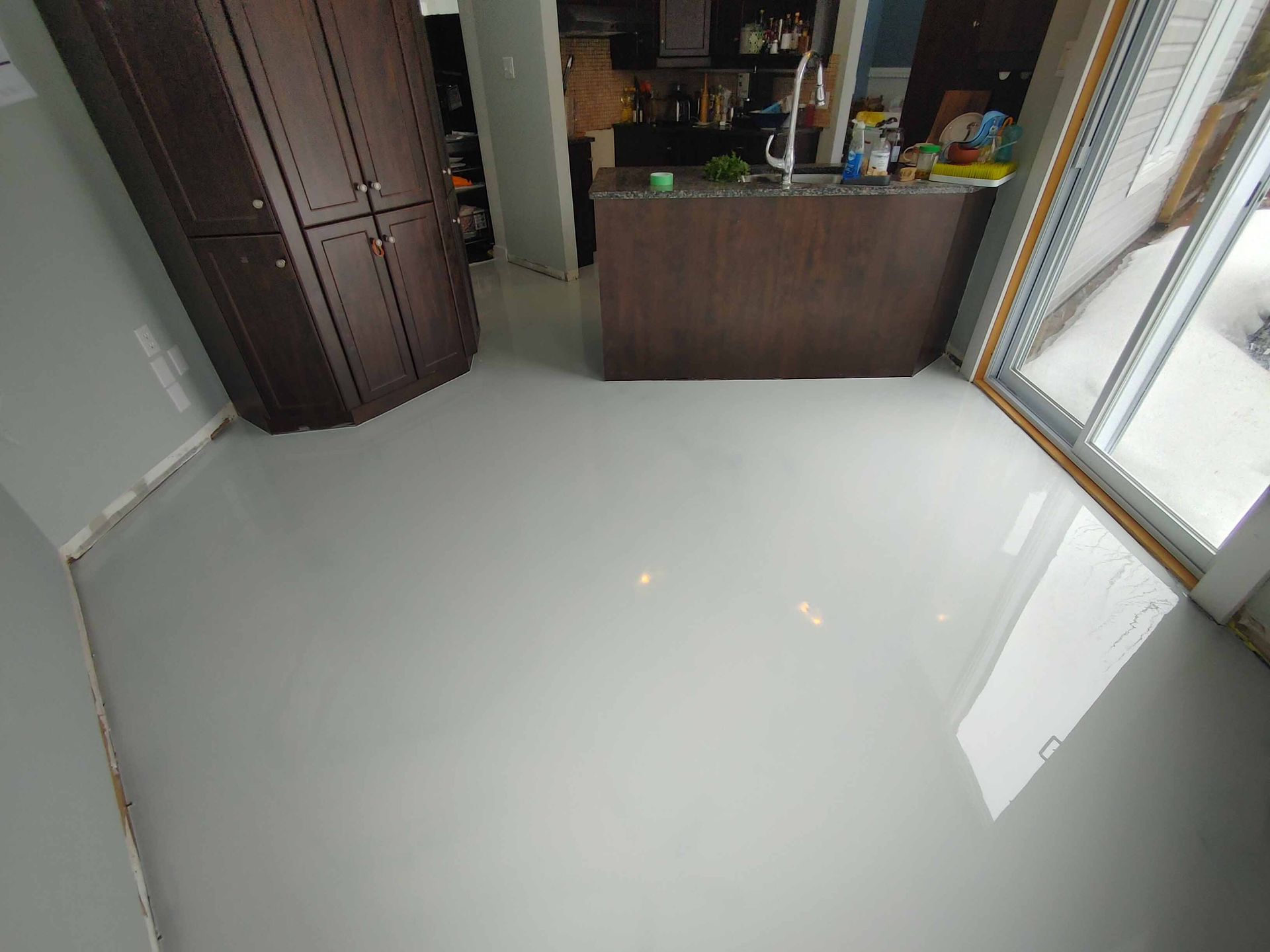 A kitchen with a white floor and a sink.