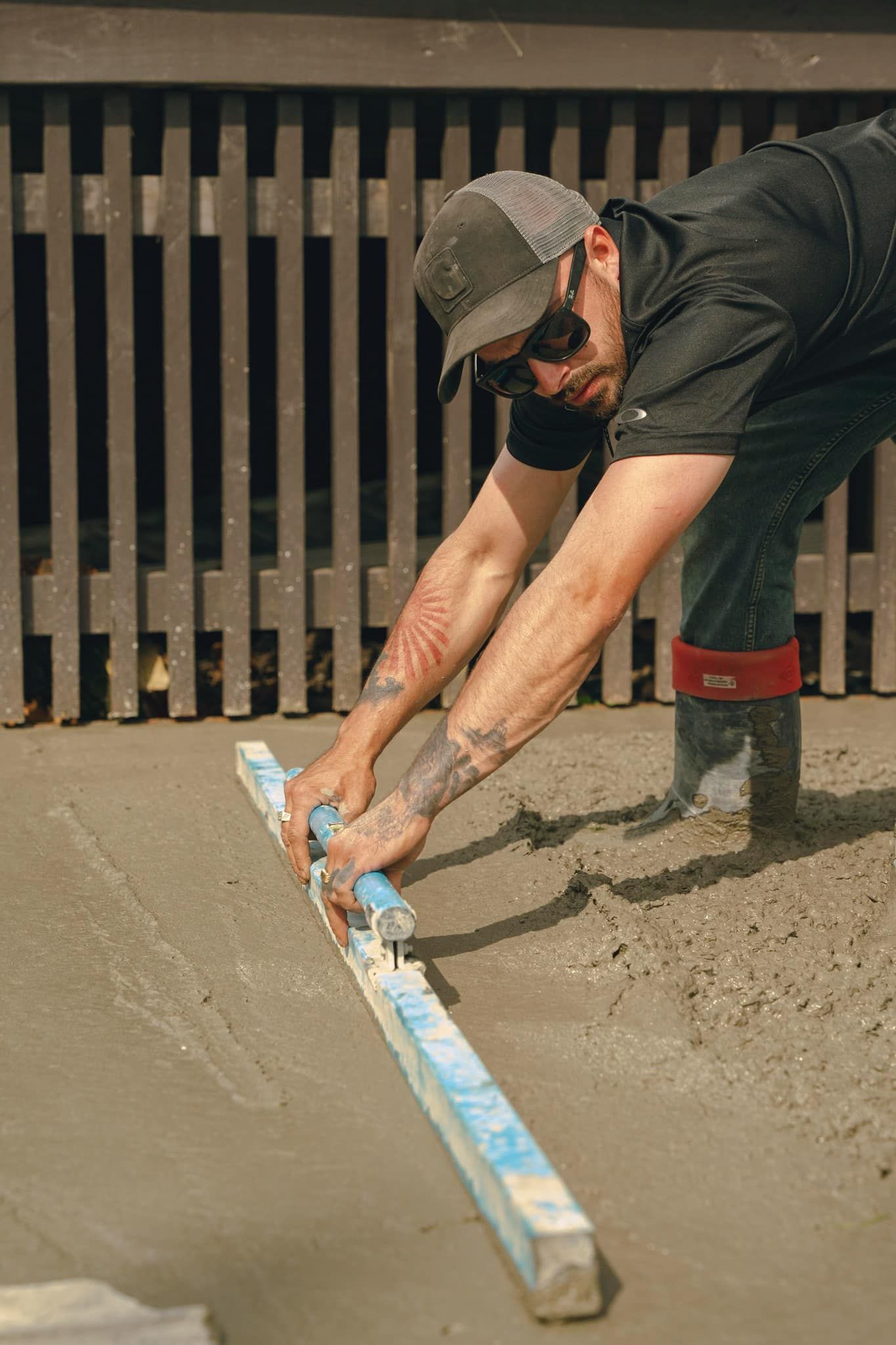 A man is using a level to measure a concrete surface.