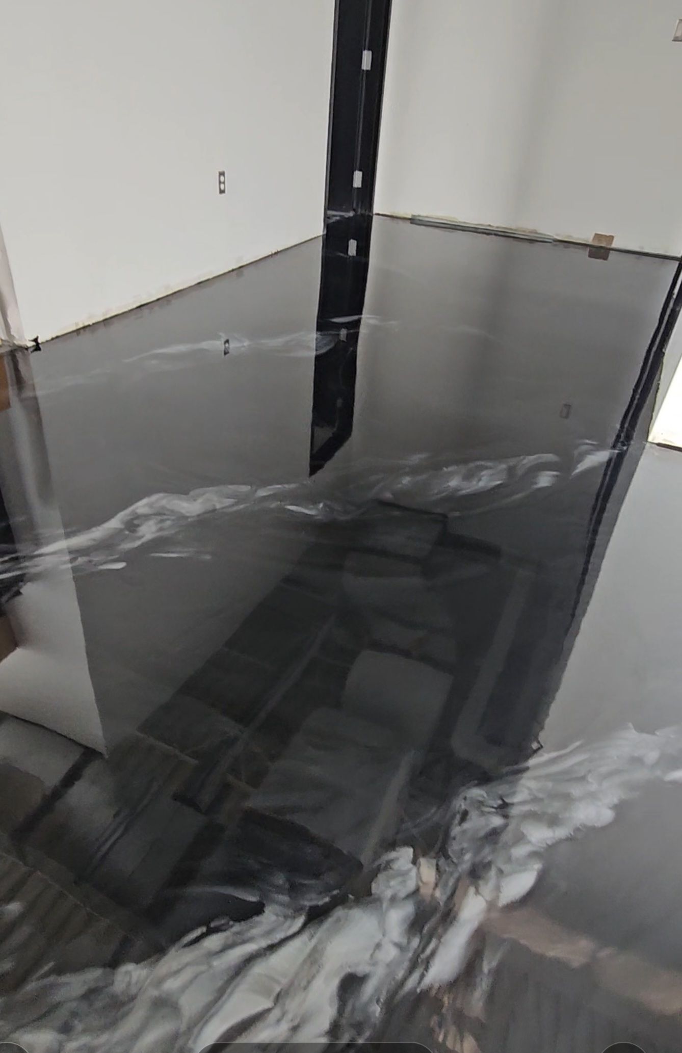 Un gros plan d'un sol en béton noir dans une pièce.