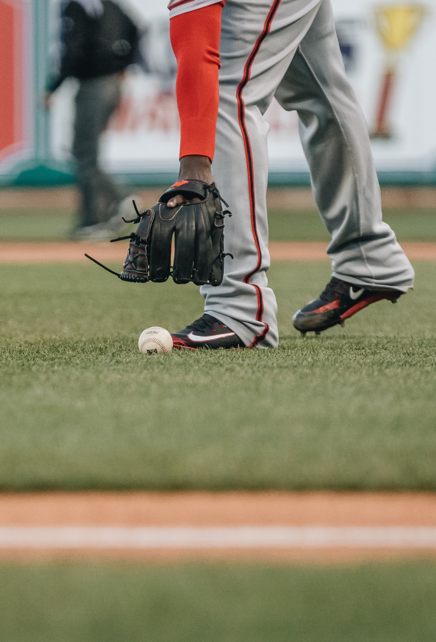 Player Picking Up Baseball. Reserve a Baseball Tournament in Mid-MO With Ballparks Central.
