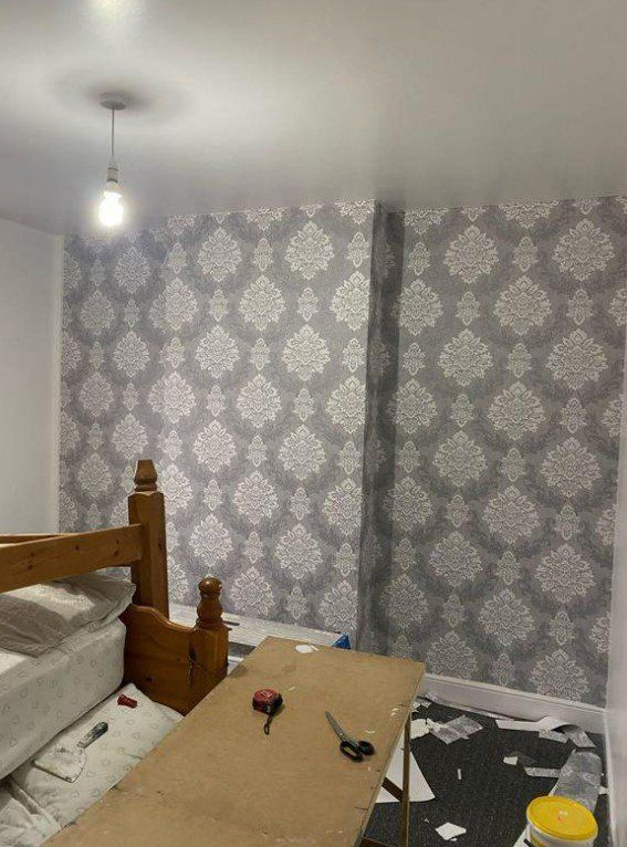 Picture of a feature wall with designer wallpaper on the feature wall. Wallpaper hanging carried out by painters and decorators Glasgow