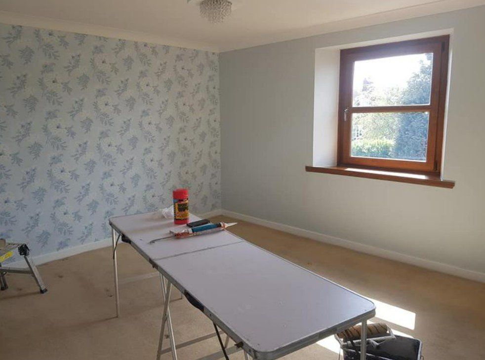 A picture of bedroom feature wall with designer wallpaper installed by painters and decorators Glasgow