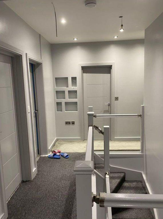Picture of a landing and staircase painted all brilliant white by painters and decorators Glasgow