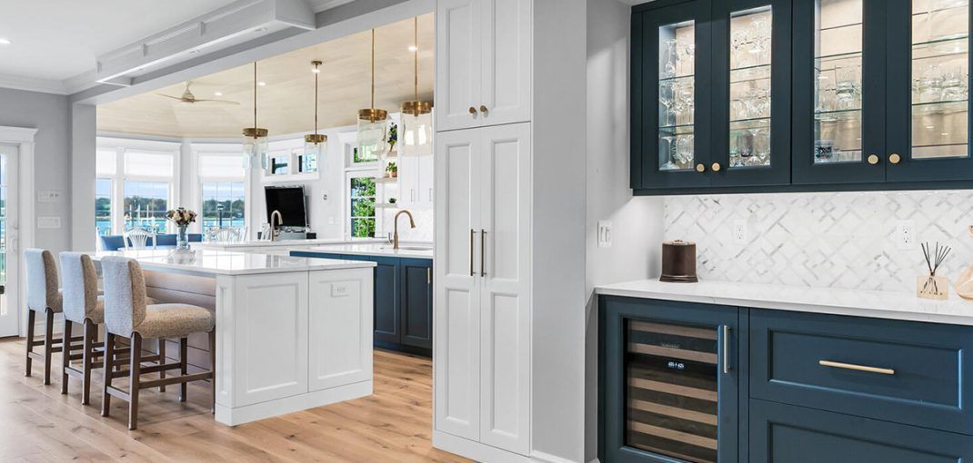 Semi-custom white and navy kitchen cabinets with custom storage and built-in beverage station.
semi custom cabinets
custom kitchen cabinetry
two tone kitchen cabinets
kitchen cabinet design
kitchen storage solutions
shaker cabinets
luxury kitchen cabinets
kitchen organization
custom cabinet upgrades
kitchen design ideas