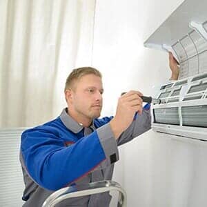 Man fixing AC — Ventilation in South Sioux City, NE