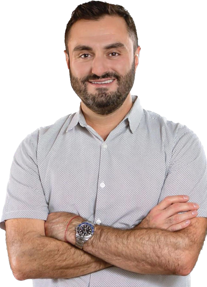 Smiling man with folded arms in a gray checkered shirt on a white background