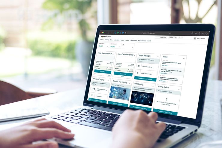 Person using a laptop showing a calendar-style scheduling app on a desk by a bright window