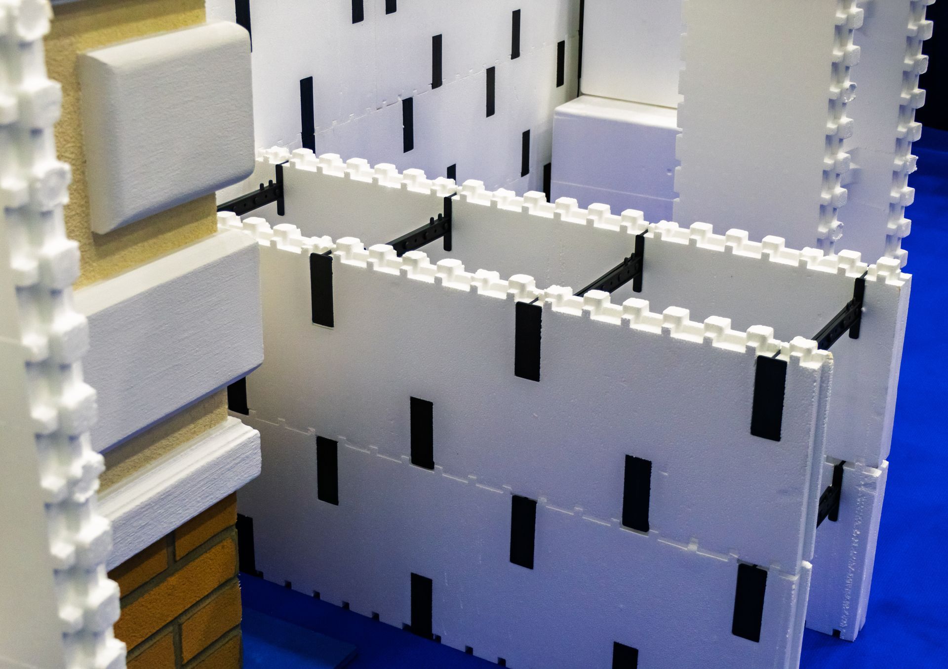 White foam construction blocks with black connectors, possibly for building insulation.